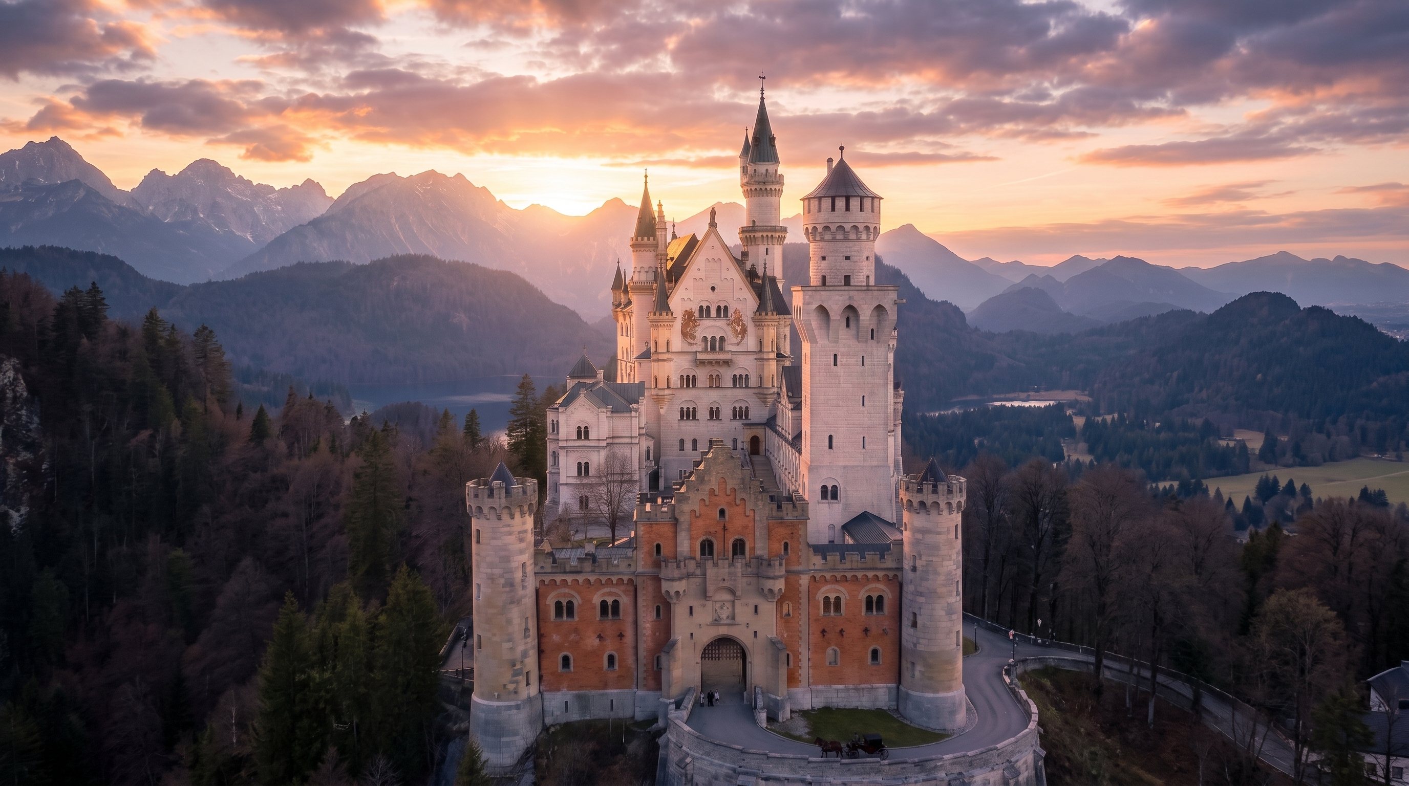 Neuschwanstein Castle at sunset with the Bavarian Alps behind